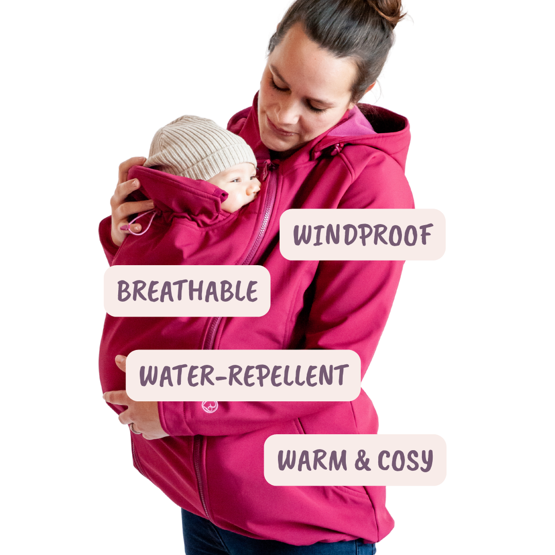 Mother wearing baby under pink softshell babywearing jacket, icons show windproof, breathable, water-repellent