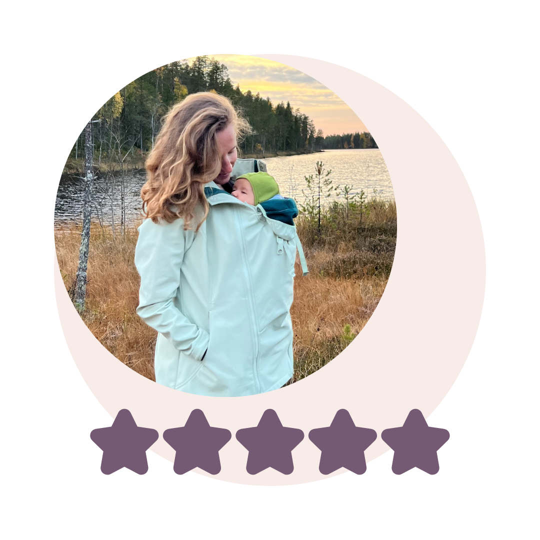 Woman carrying baby in mint green softshell jacket by lake, with five star rating below